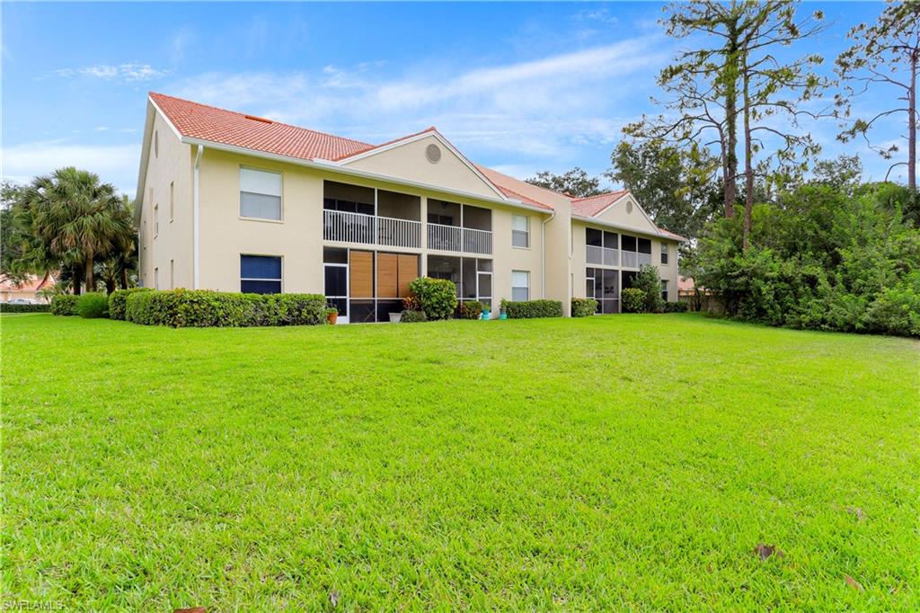 337 Robin Hood Circle, Unit 204 Naples, FL 34104 - Photo 20 of 23 a view of a house with a yard