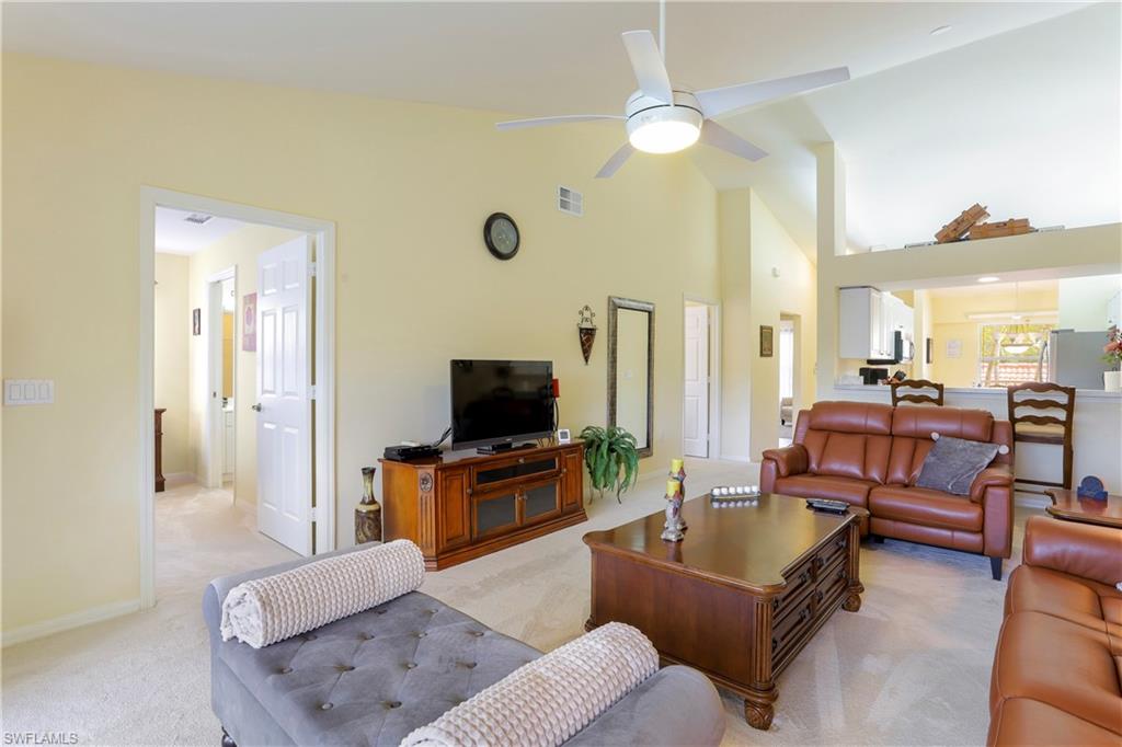 337 Robin Hood Circle, Unit 204 Naples, FL 34104 - Photo 2 of 23 a living room with furniture and a flat screen tv