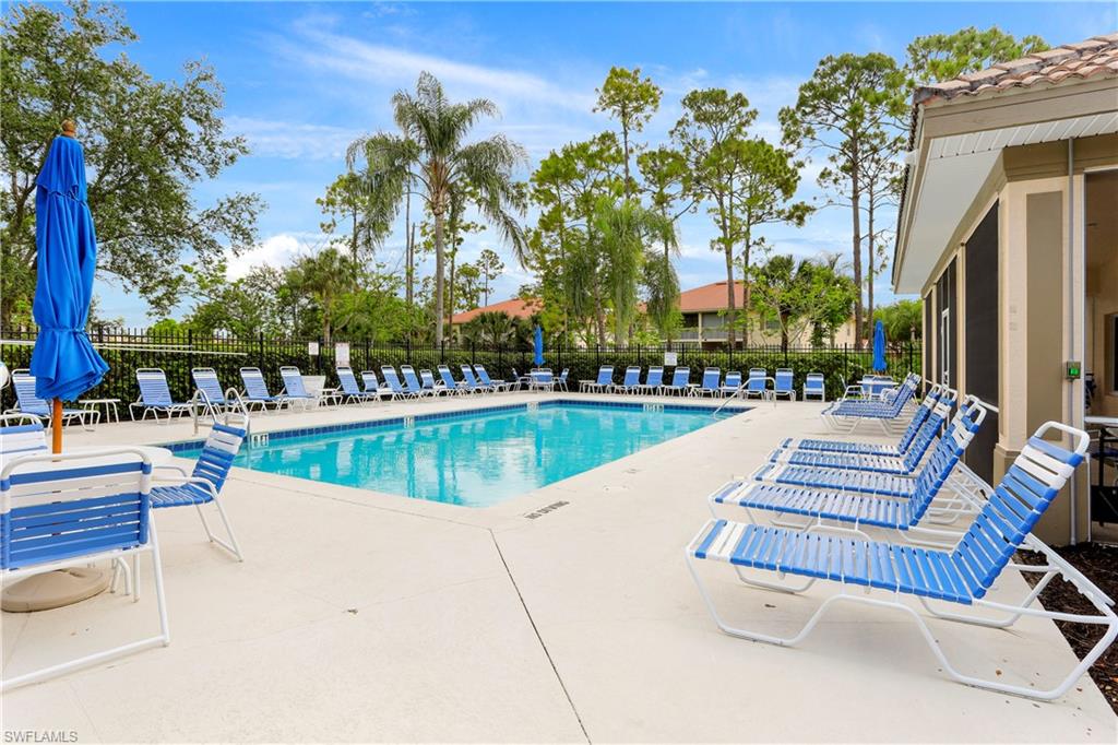 337 Robin Hood Circle, Unit 204 Naples, FL 34104 - Photo 22 of 23 a view of swimming pool with chairs