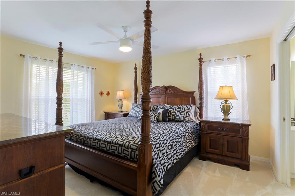 337 Robin Hood Circle, Unit 204 Naples, FL 34104 - Photo 5 of 23 a bedroom with a bed and window