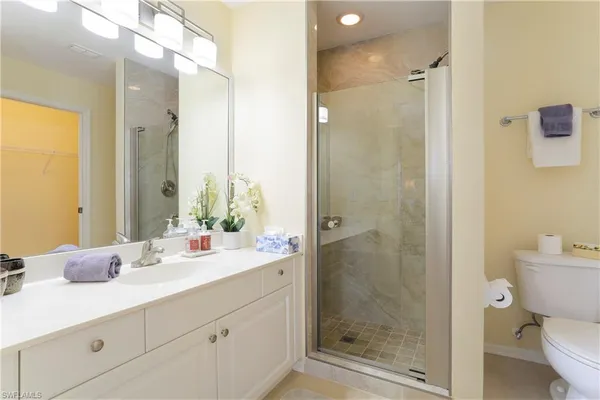 a bathroom with a shower sink and mirror
