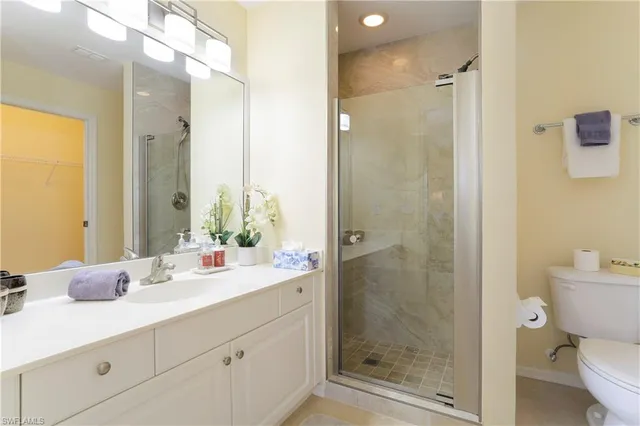 a bathroom with a shower sink and mirror