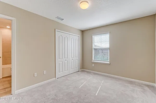 a view of an empty room and closet area