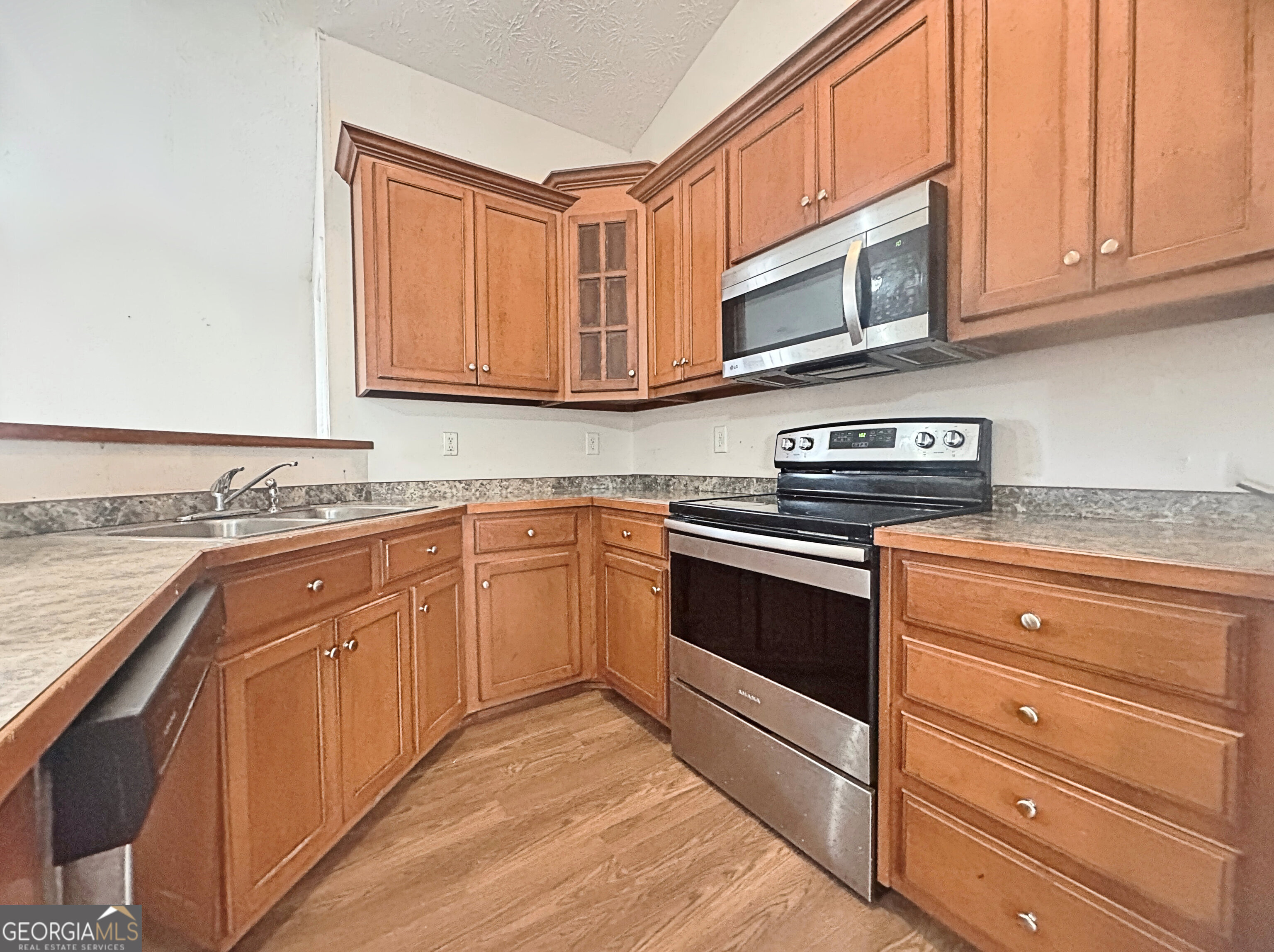 203 Jerry Road Hogansville, GA 30230 - Photo 11 of 49 a kitchen with granite countertop cabinets stainless steel appliances and a sink