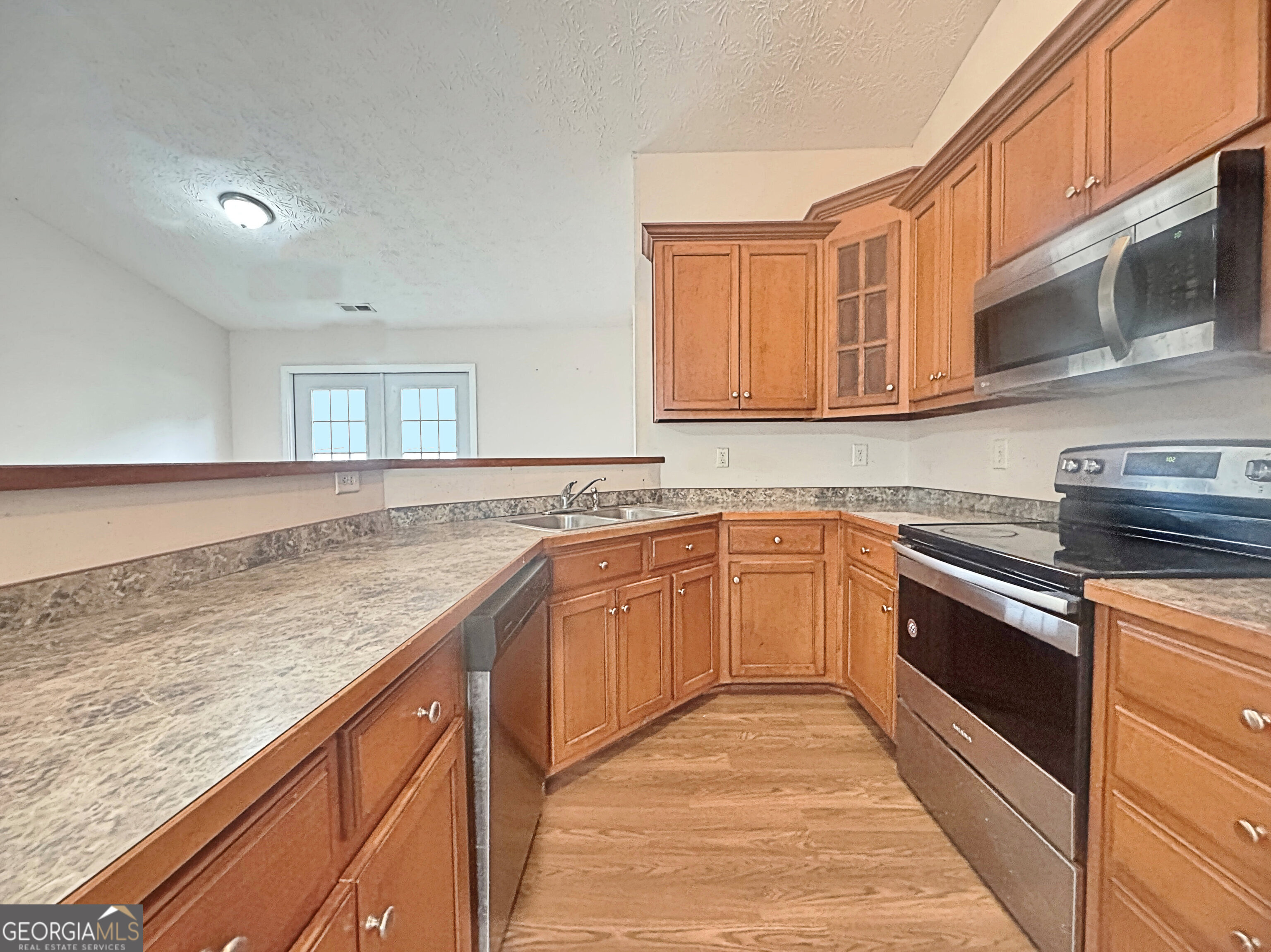 203 Jerry Road Hogansville, GA 30230 - Photo 12 of 51 a kitchen with granite countertop stainless steel appliances and cabinets