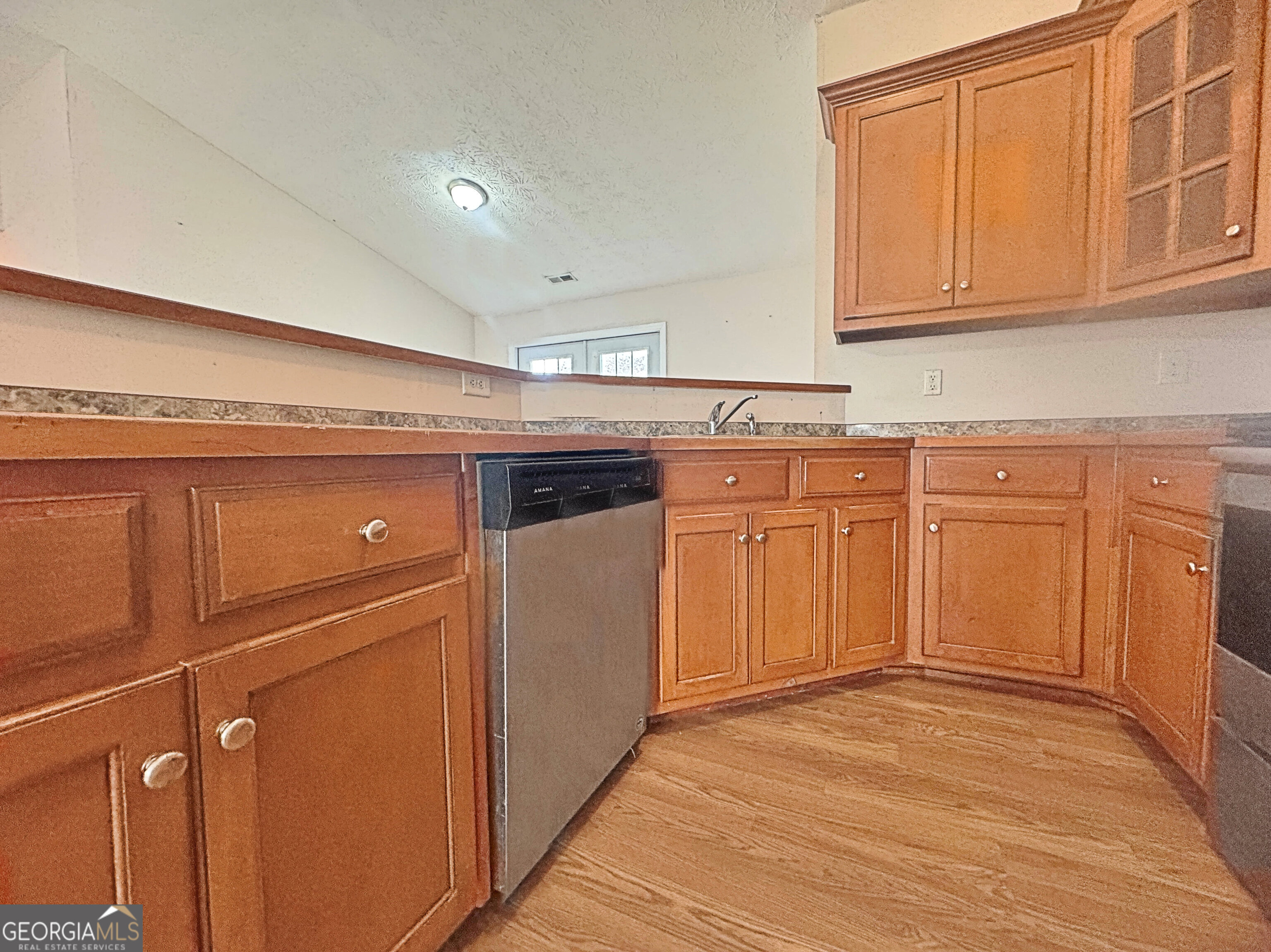 203 Jerry Road Hogansville, GA 30230 - Photo 12 of 49 a kitchen with granite countertop cabinets stainless steel appliances and a sink