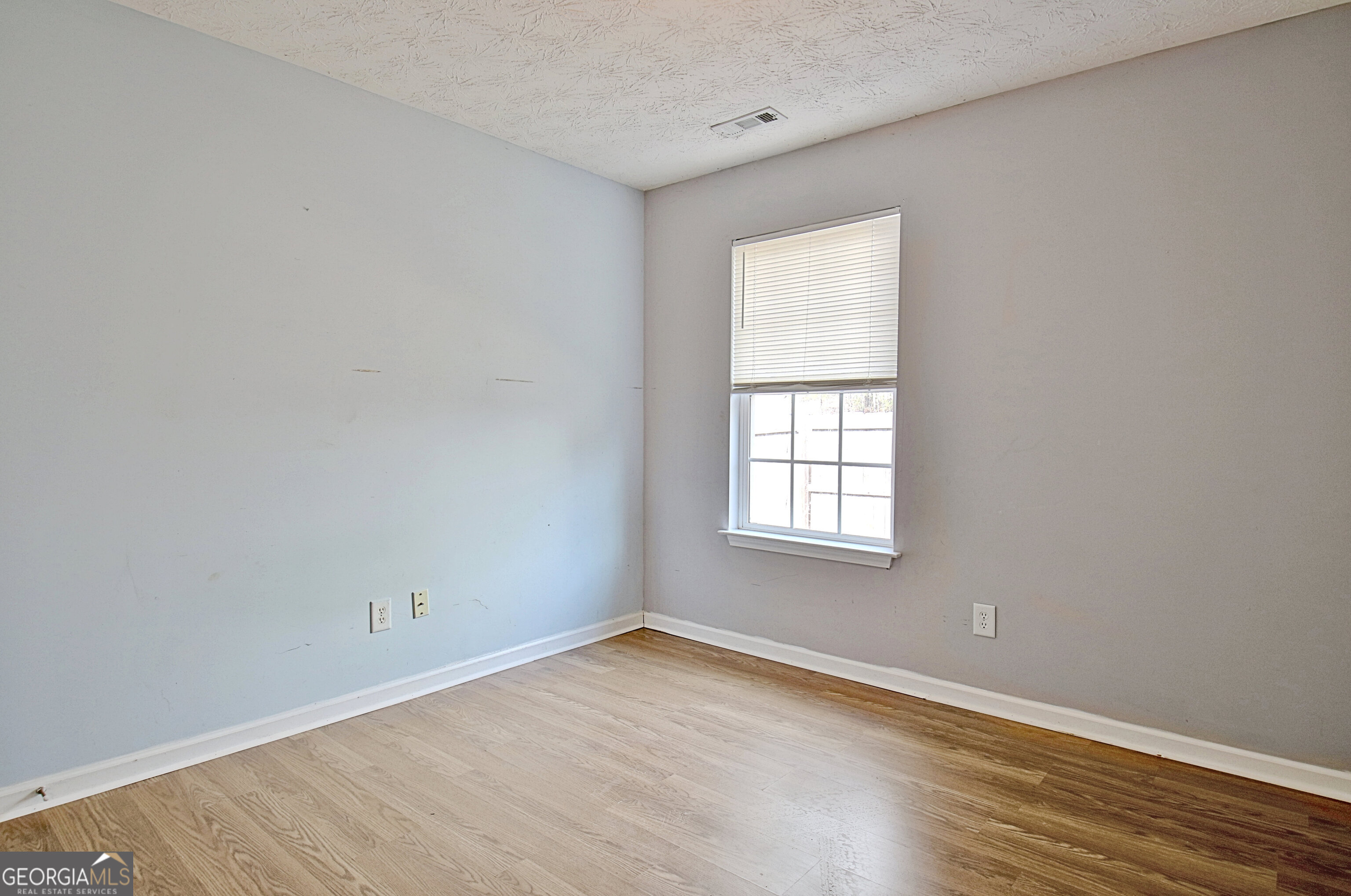 203 Jerry Road Hogansville, GA 30230 - Photo 26 of 51 an empty room with wooden floor and windows
