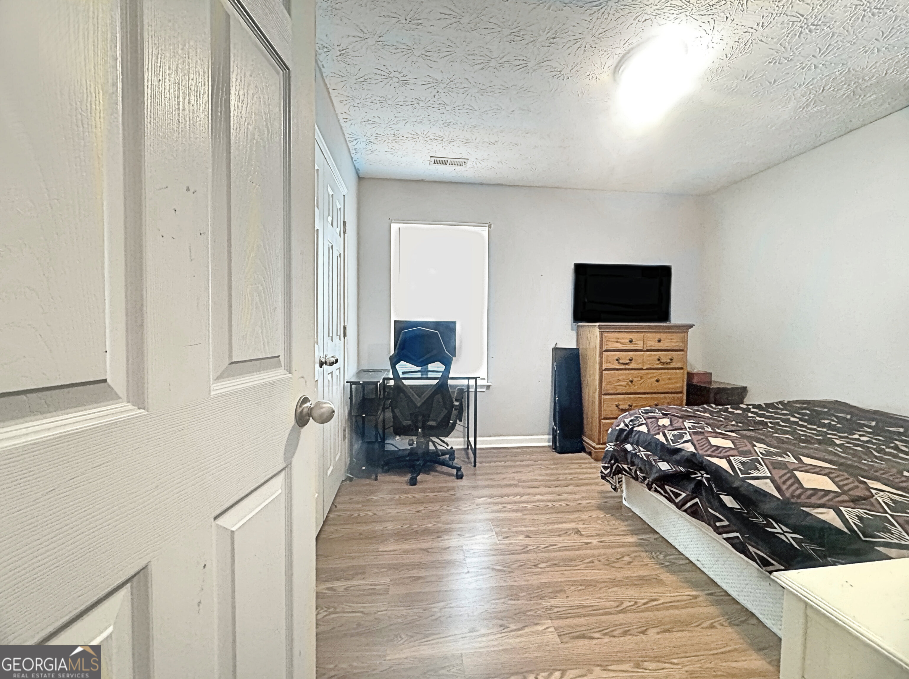 203 Jerry Road Hogansville, GA 30230 - Photo 35 of 49 a bedroom with furniture a flat screen tv and a fireplace