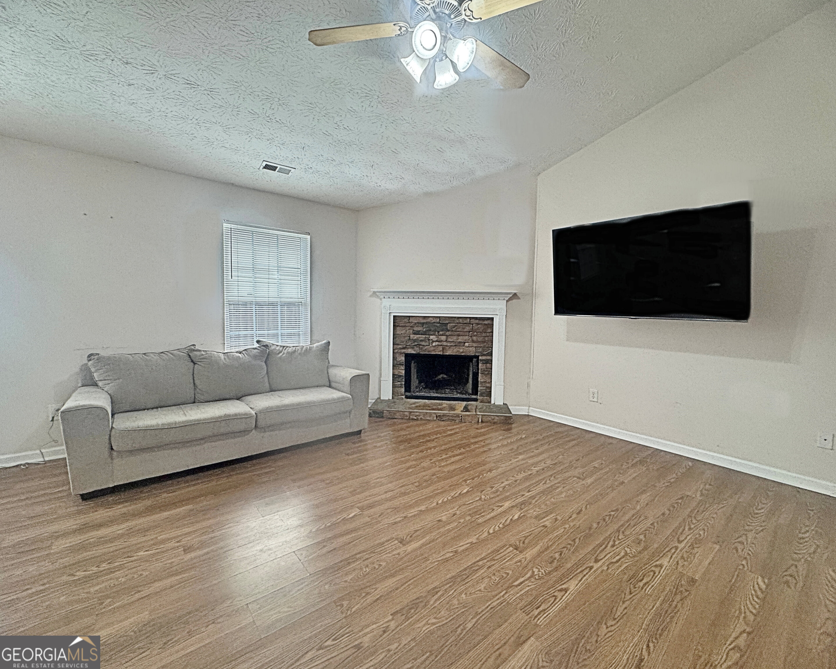 203 Jerry Road Hogansville, GA 30230 - Photo 9 of 51 a living room with furniture a flat screen tv and a fireplace