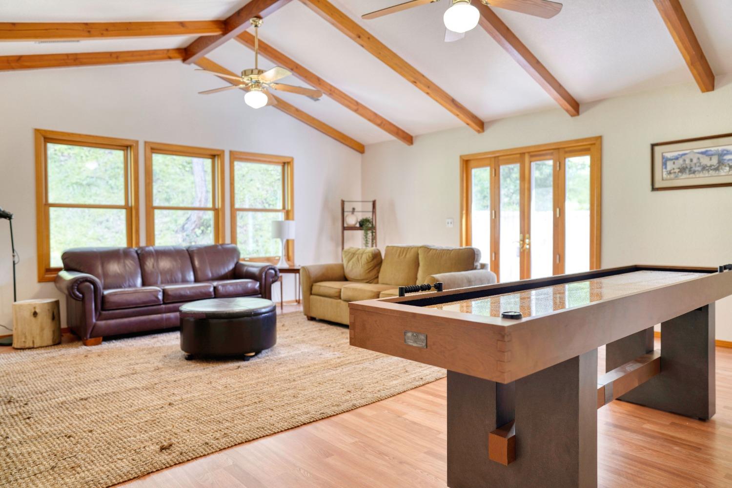 42917 Scenic Drive Oakhurst, CA 93644 - Photo 14 of 50 a living room with furniture a flat screen tv and a large window