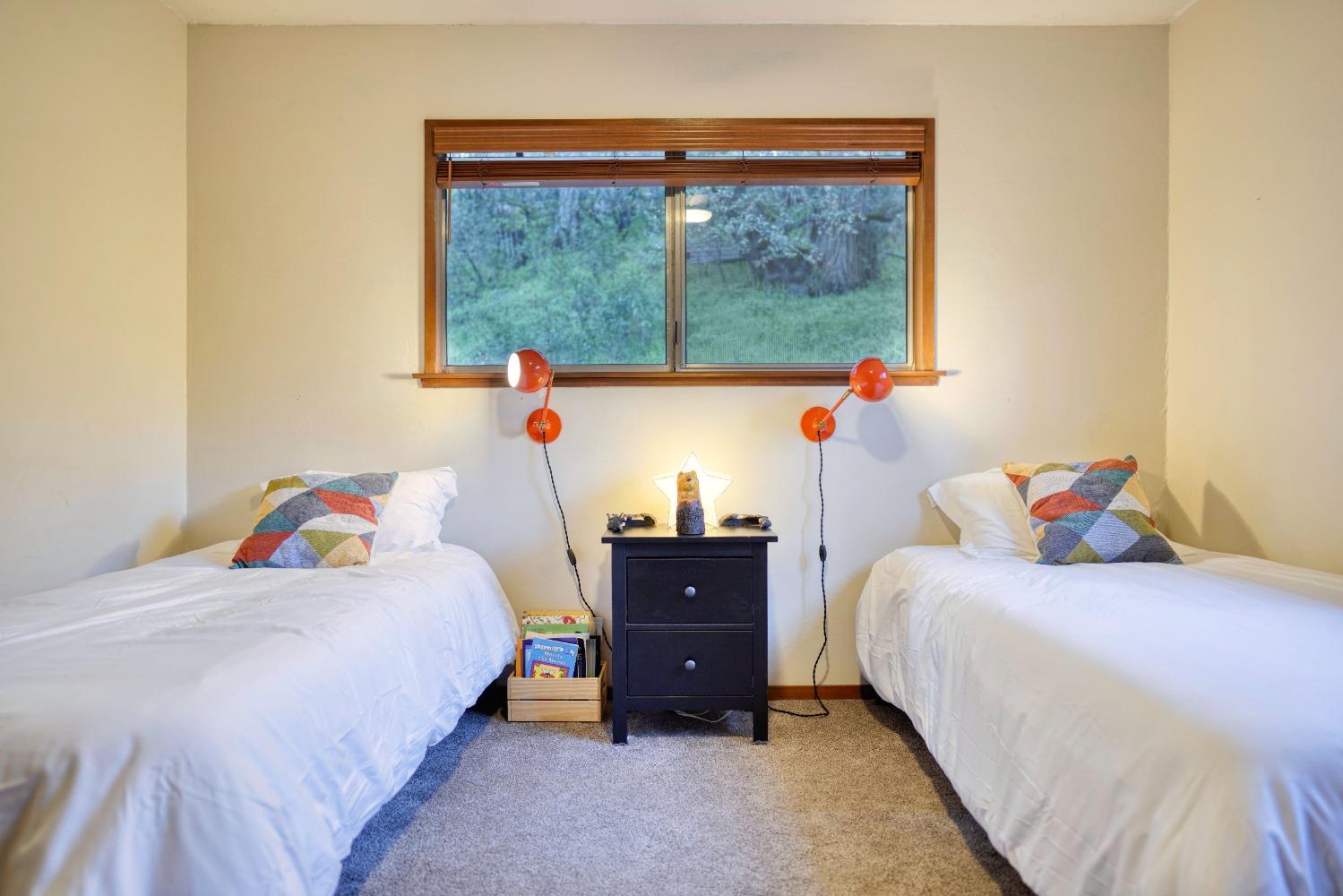 42917 Scenic Drive Oakhurst, CA 93644 - Photo 24 of 50 a bedroom with a bed and a large window