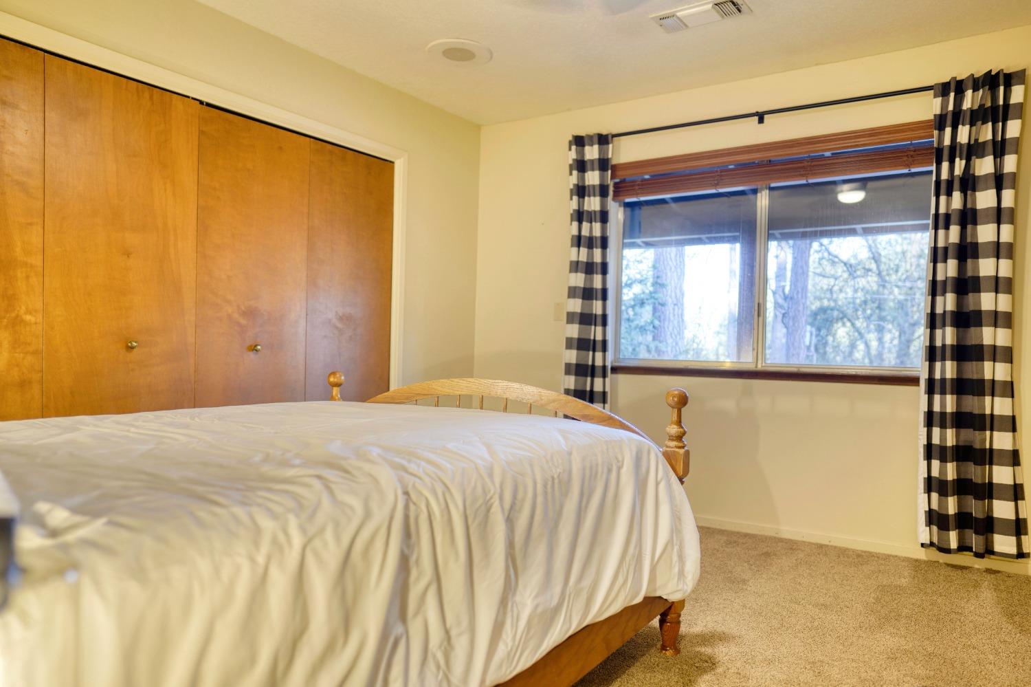 42917 Scenic Drive Oakhurst, CA 93644 - Photo 25 of 50 a bedroom with a bed and a window