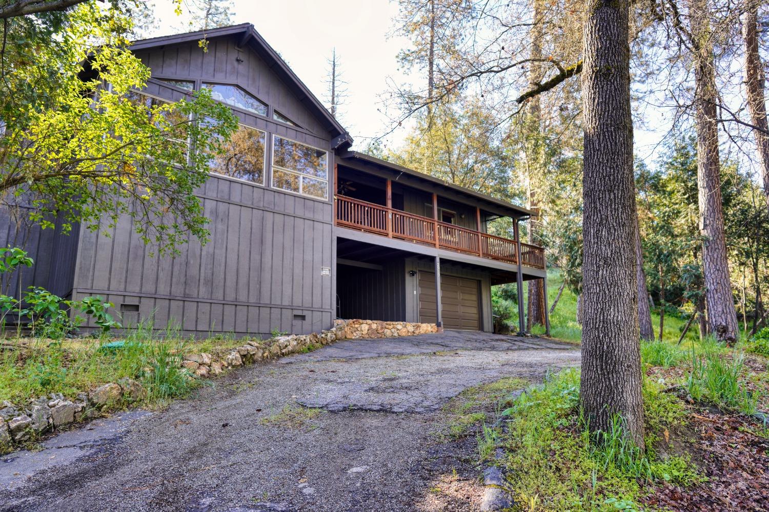 42917 Scenic Drive Oakhurst, CA 93644 - Photo 35 of 50 a front view of a house with a garden