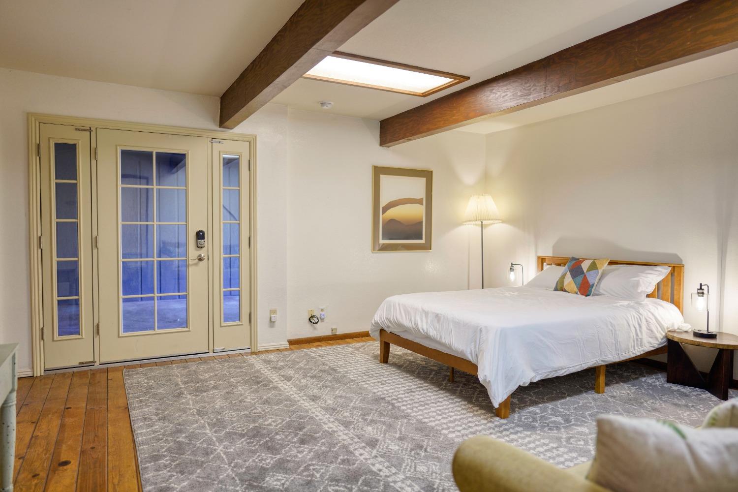 42917 Scenic Drive Oakhurst, CA 93644 - Photo 41 of 50 a spacious bedroom with a bed and a couch