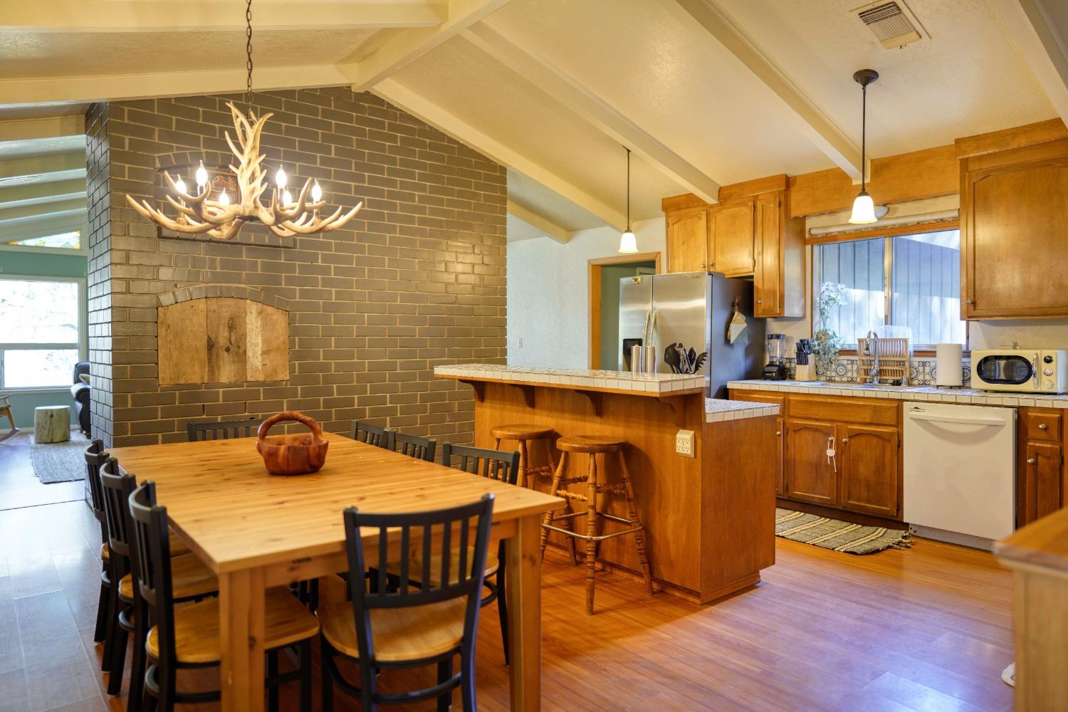 42917 Scenic Drive Oakhurst, CA 93644 - Photo 44 of 50 a kitchen with a dining table chairs sink and stove