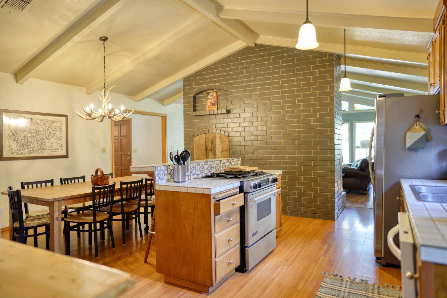 42917 Scenic Drive Oakhurst, CA 93644 - Photo 45 of 50 a kitchen with stove and wooden floor
