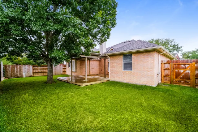 a view of a house with a yard and sitting area