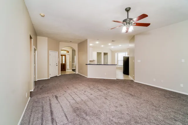 a view of a kitchen with a sink and a refrigerator