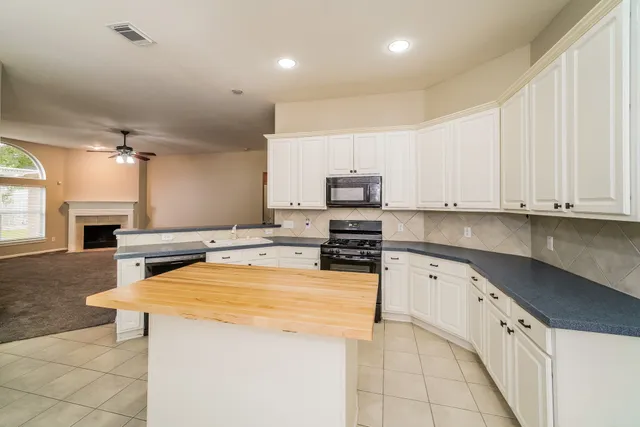 a kitchen with stainless steel appliances a stove sink microwave and cabinets