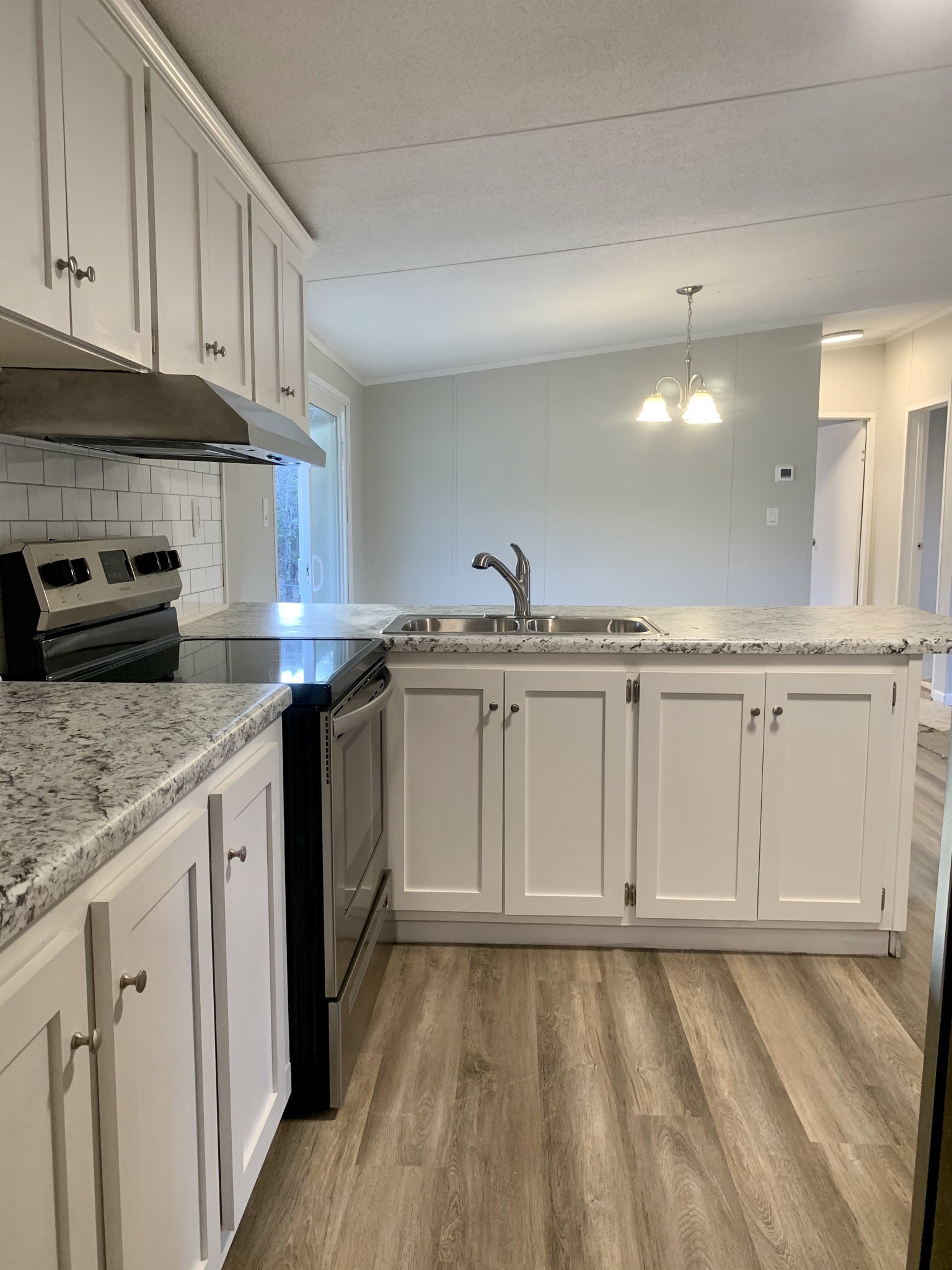 784 Speck Road Lebanon, TN 37087 - Photo 11 of 35 a kitchen with granite countertop white cabinets and white appliances