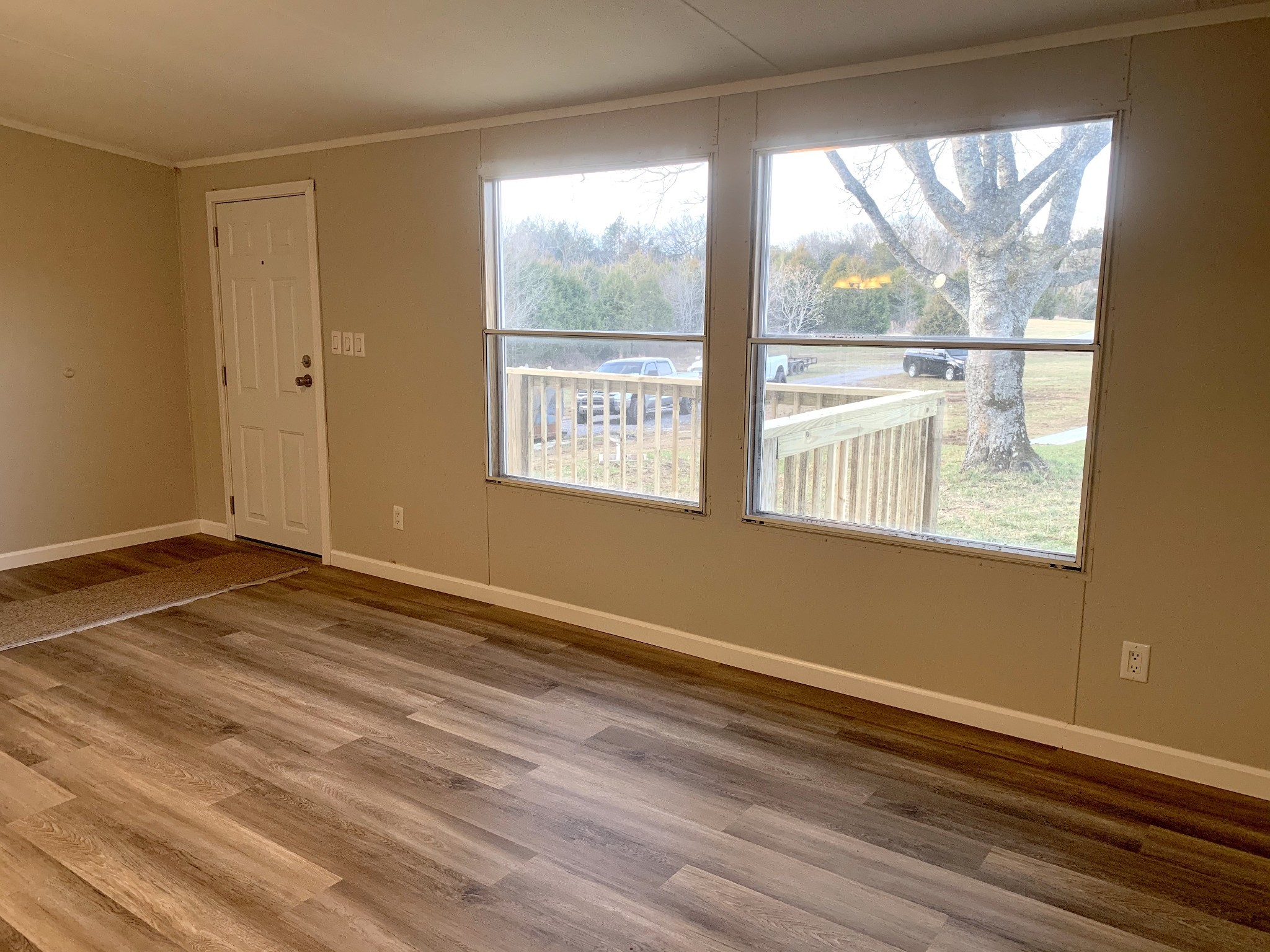 784 Speck Road Lebanon, TN 37087 - Photo 13 of 35 a view of an empty room with wooden floor and a window