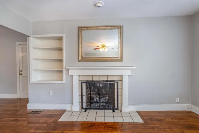 a living room with a fireplace and a floor to ceiling window