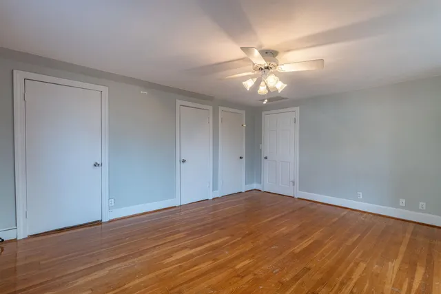 a view of an empty room with a fan