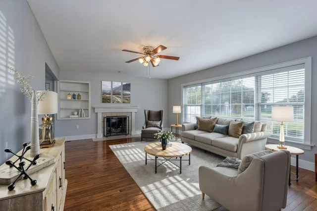 a living room with furniture a fireplace and a flat screen tv
