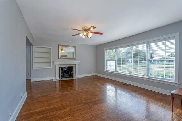 a view of a livingroom with a fireplace and window