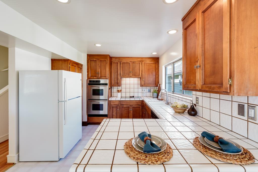 918 3rd Street, Unit A Santa Cruz, CA 95060 - Photo 17 of 43 a kitchen with a refrigerator and a stove top oven
