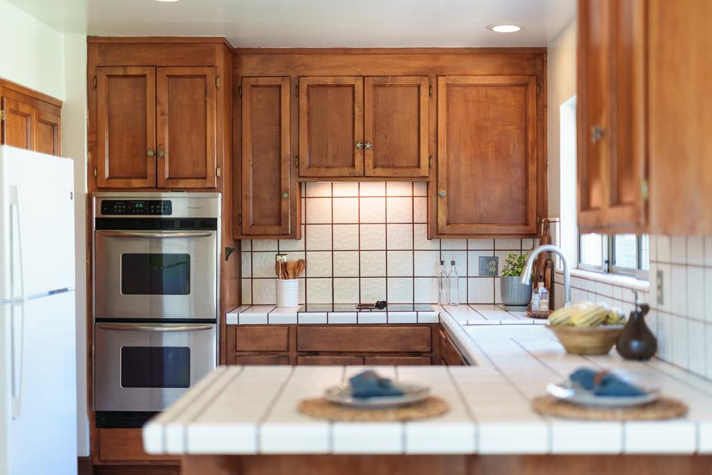 918 3rd Street, Unit A Santa Cruz, CA 95060 - Photo 19 of 43 a kitchen with granite countertop a stove a sink and a cabinets