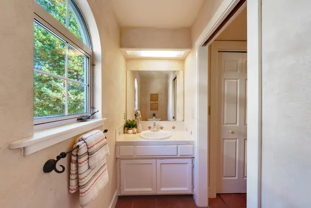 a bathroom with a sink mirror and vanity