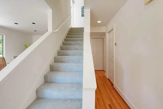 a view of entryway and hall with wooden floor