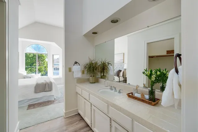 a bathroom with a granite countertop sink and a mirror