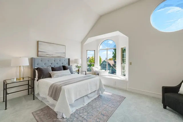 a bedroom with a large bed and a window