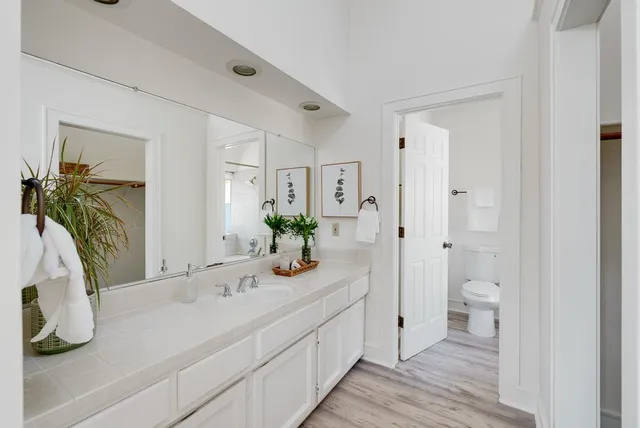 a bathroom with a tub shower and a toilet