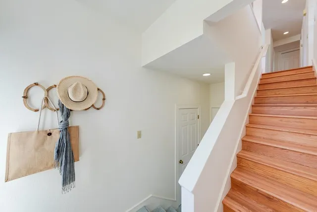 a view of entryway and hall with wooden floor
