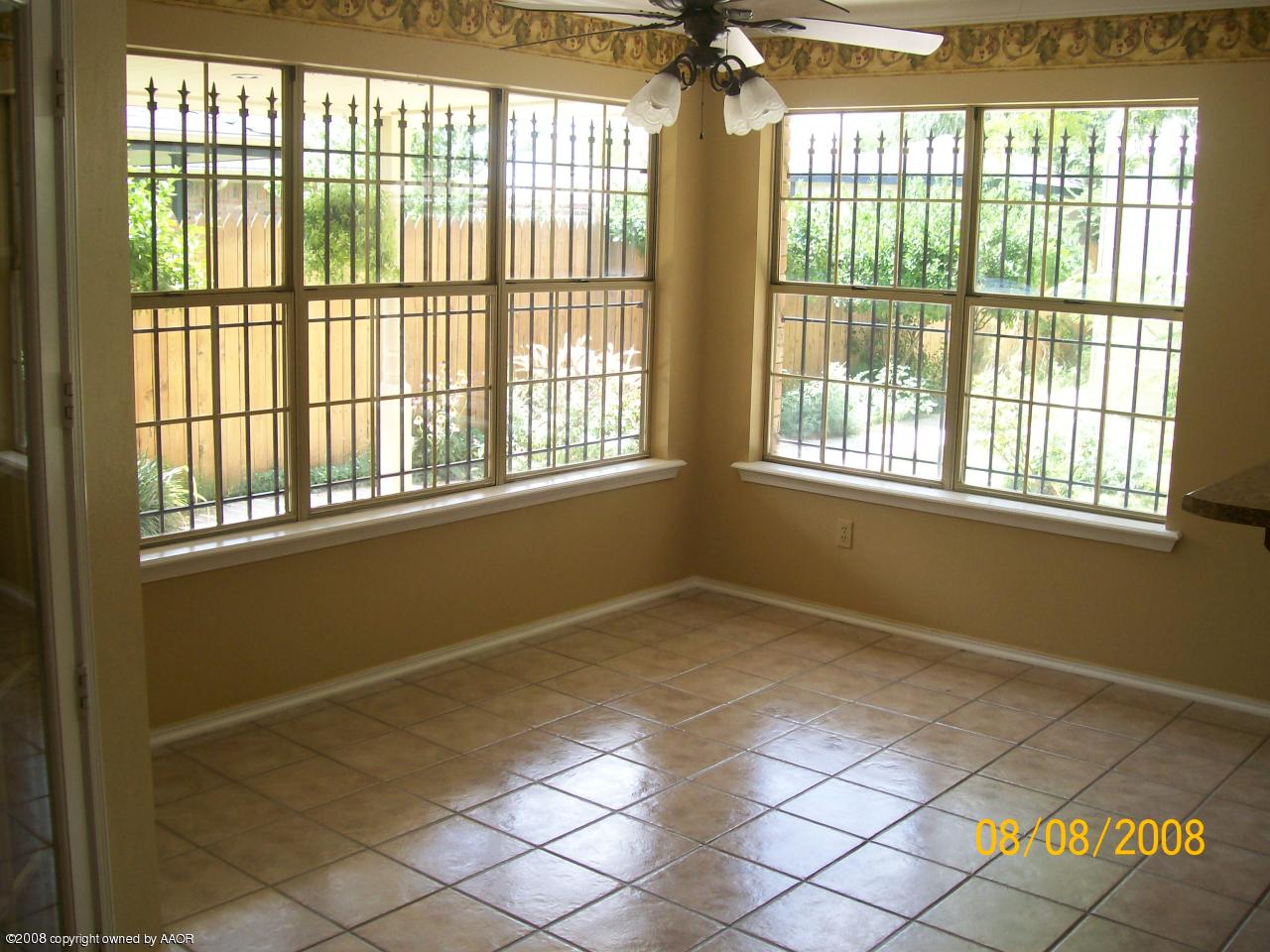 8008 Claret Street Amarillo, TX 79110 - Photo 3 of 9 a view of an empty room with a window