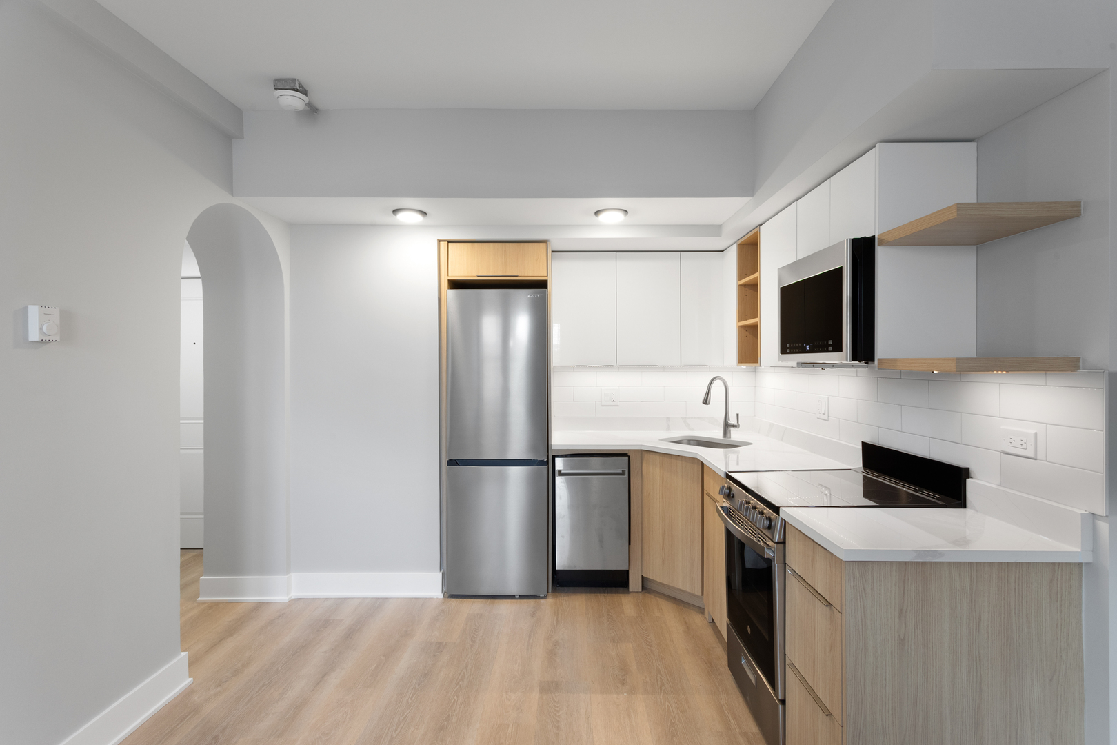 1634 West Howard Street, Unit 309 Chicago, IL 60626 - Photo 6 of 9 a kitchen with a sink a refrigerator and a stove top oven