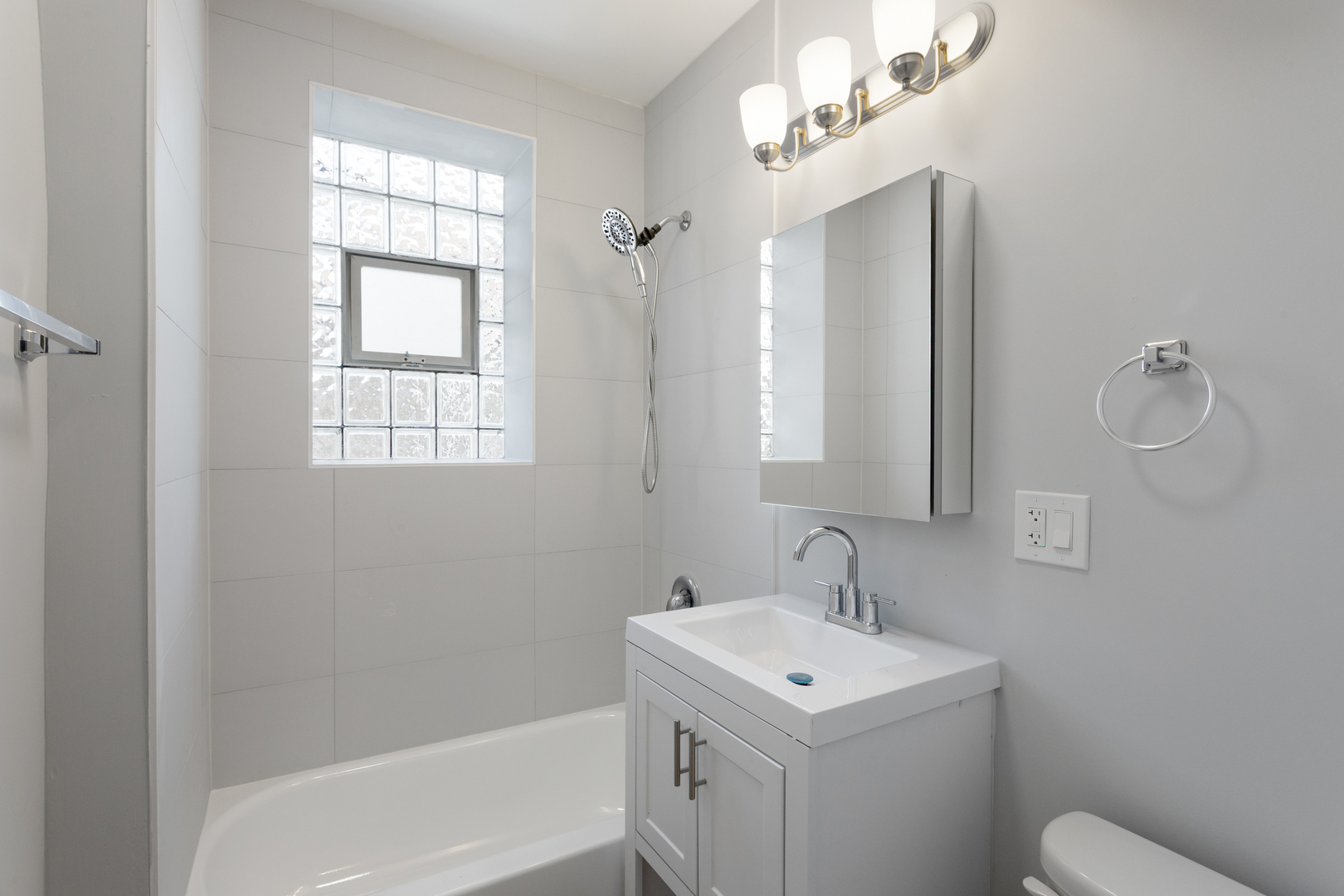 1634 West Howard Street, Unit 309 Chicago, IL 60626 - Photo 9 of 9 a bathroom with a sink a toilet and shower