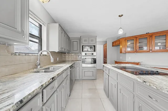 a kitchen that has a sink and a stove