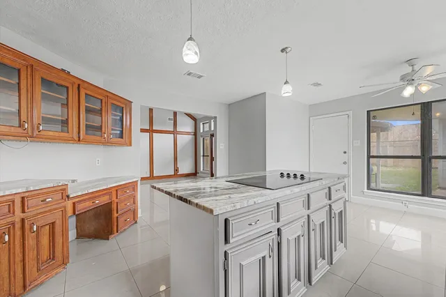 a kitchen that has a lot of cabinets in it