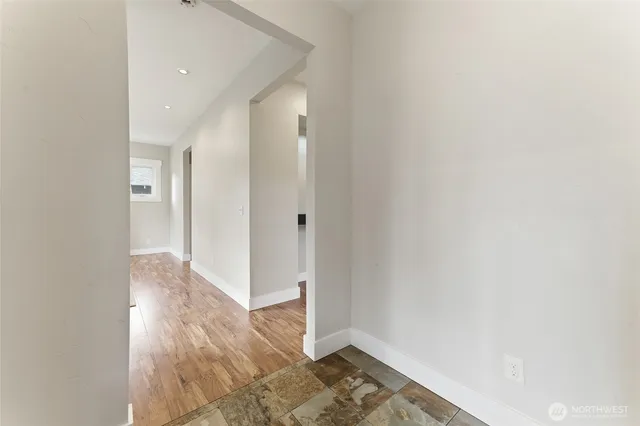 a view of a hallway with wooden floor