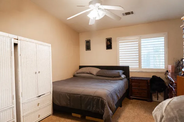 a bedroom with a bed and a chandelier
