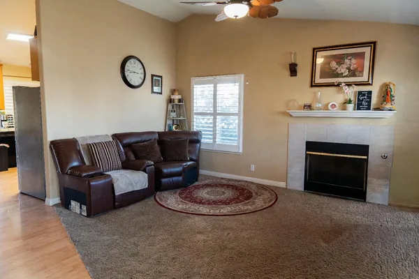 a living room with furniture a fireplace and a window