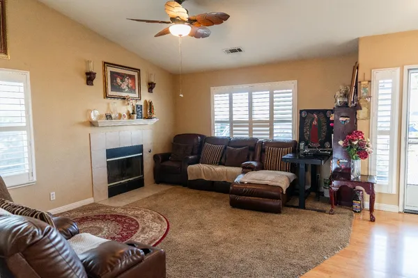 a living room with furniture fireplace and window