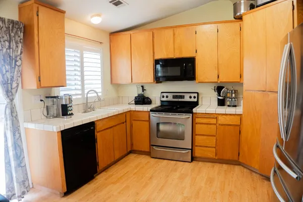 a kitchen with a sink stove and microwave