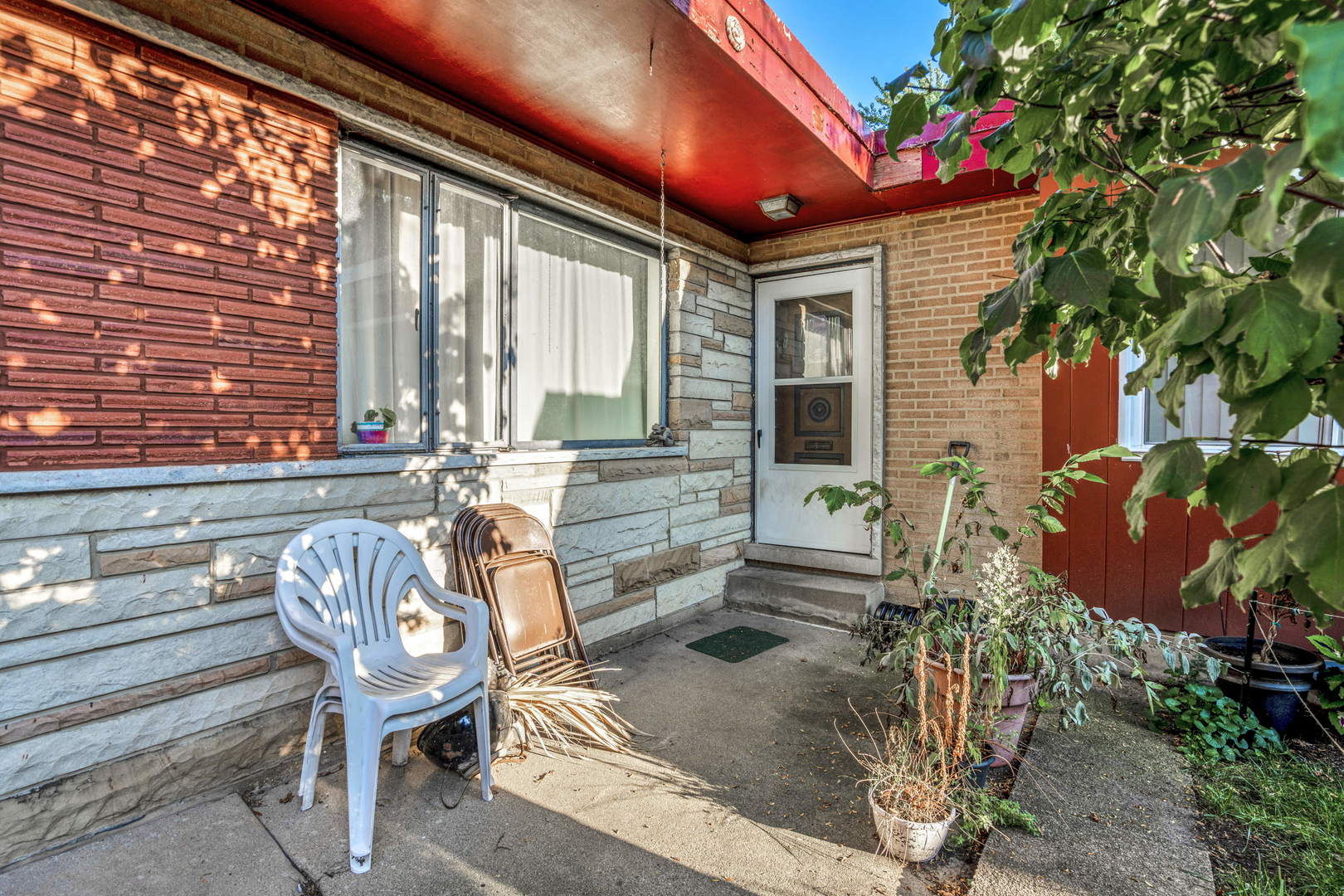 243 Custer Avenue Evanston, IL 60202 - Photo 3 of 17 a roof deck with table and chairs and potted plants