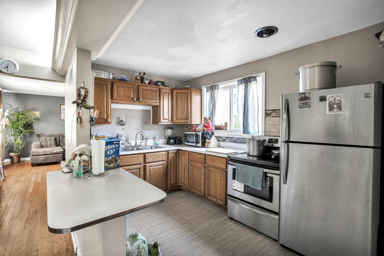 243 Custer Avenue Evanston, IL 60202 - Photo 8 of 17 a kitchen with granite countertop a refrigerator a sink a stove and white cabinets