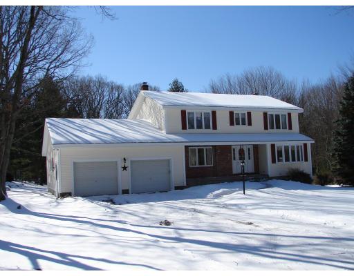 a view of a house with a garden and deck